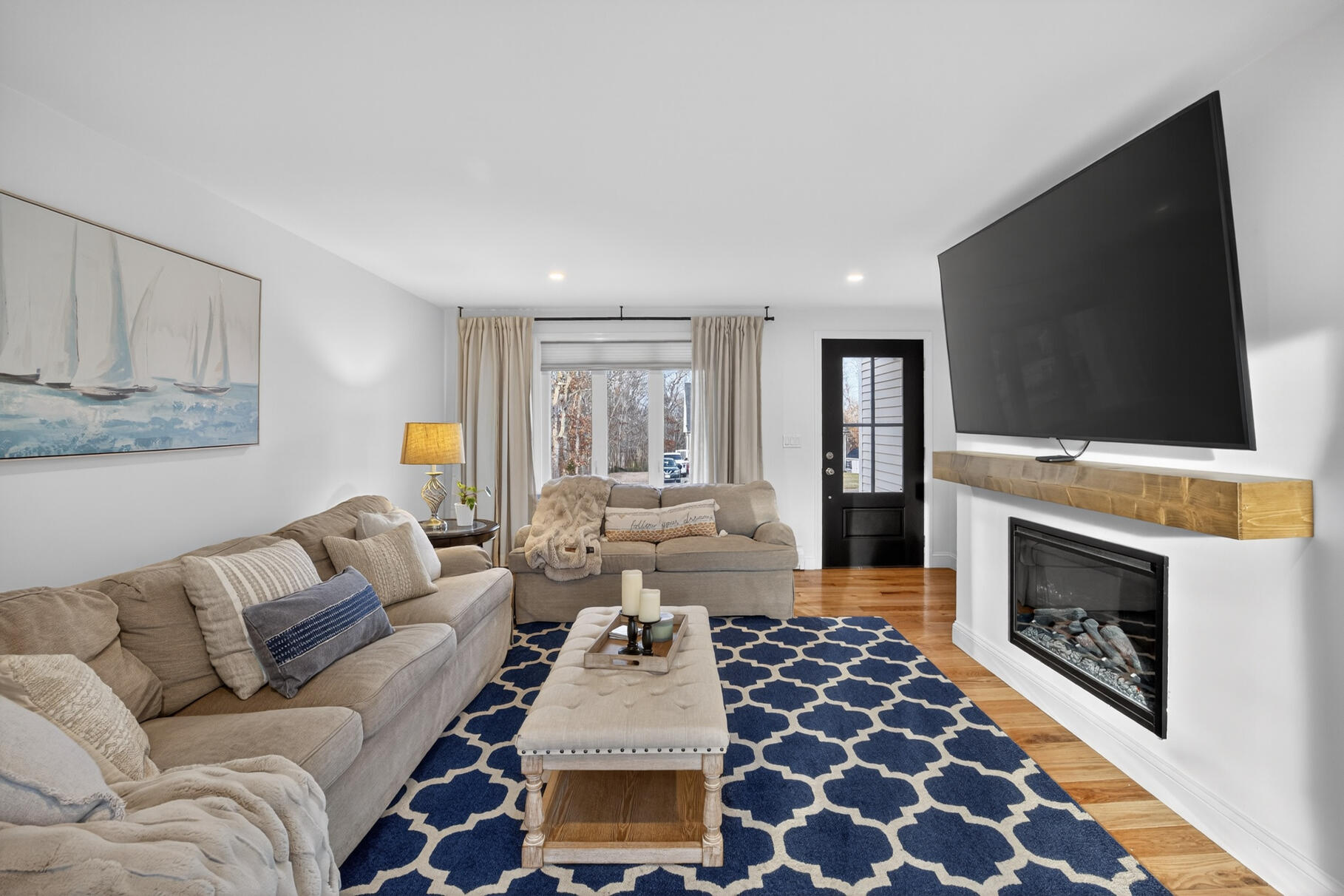 24 Surrey Lane Sandwich, MA 02563 - Photo 21 of 61 a living room with furniture a flat screen tv and a fireplace