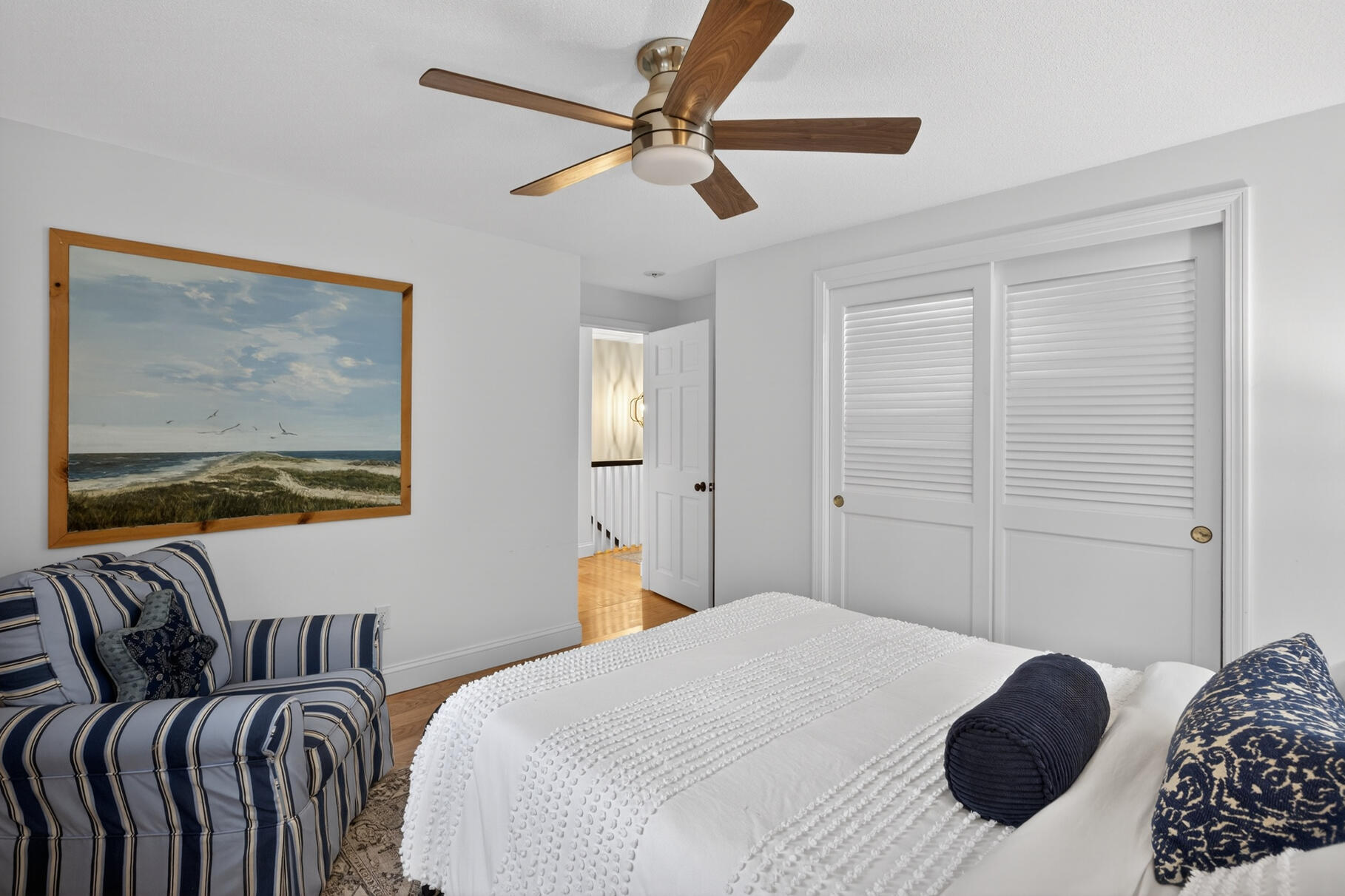 24 Surrey Lane Sandwich, MA 02563 - Photo 40 of 61 a bedroom with a bed and wooden floor