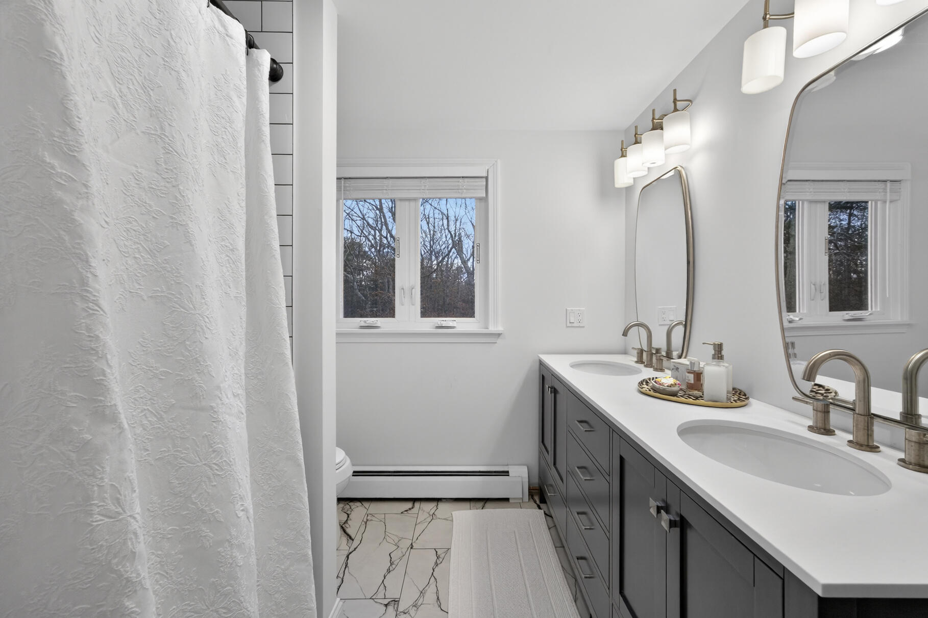 24 Surrey Lane Sandwich, MA 02563 - Photo 42 of 61 a bathroom with a double vanity sink and mirror