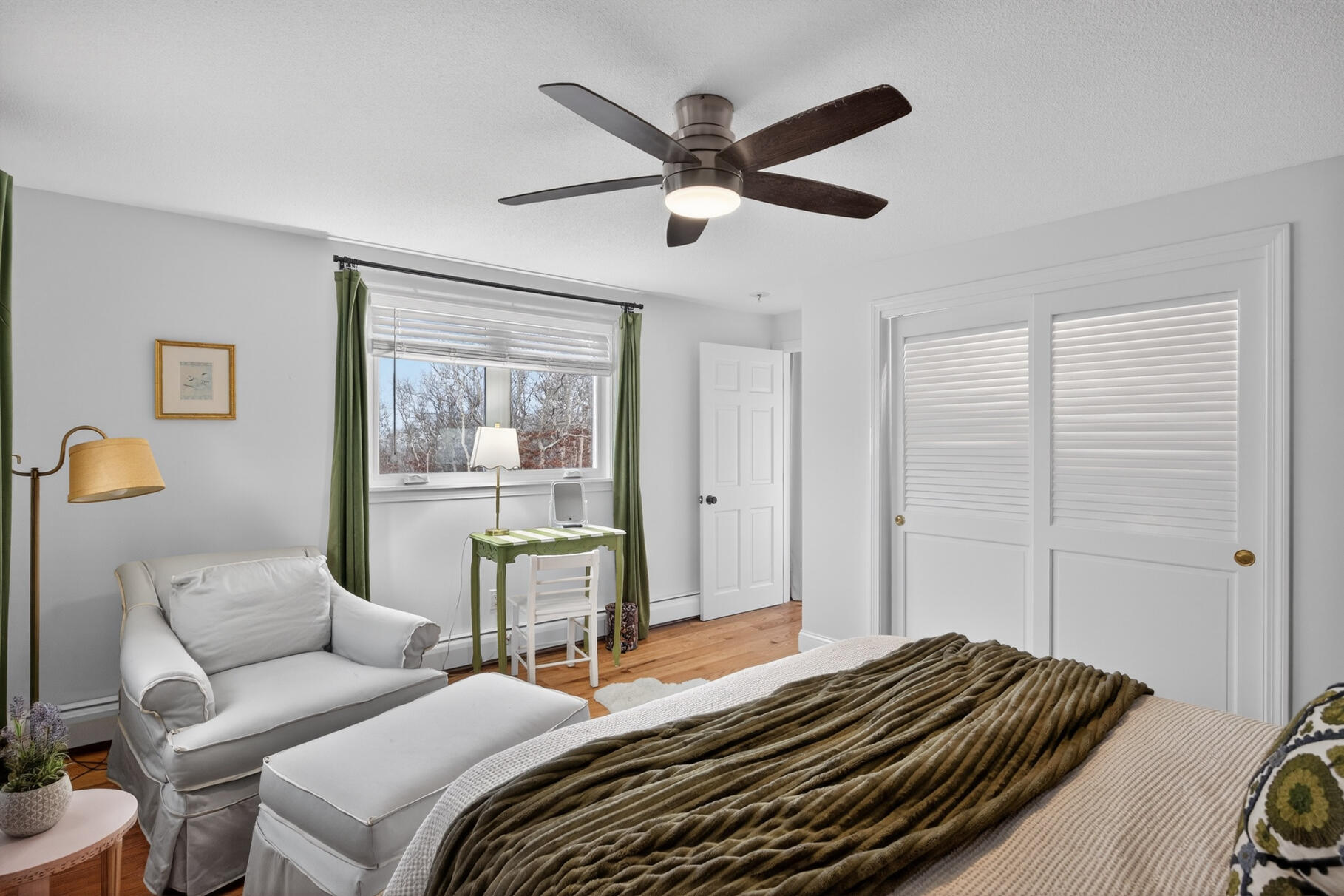 24 Surrey Lane Sandwich, MA 02563 - Photo 49 of 61 a bedroom with a bed and a chandelier