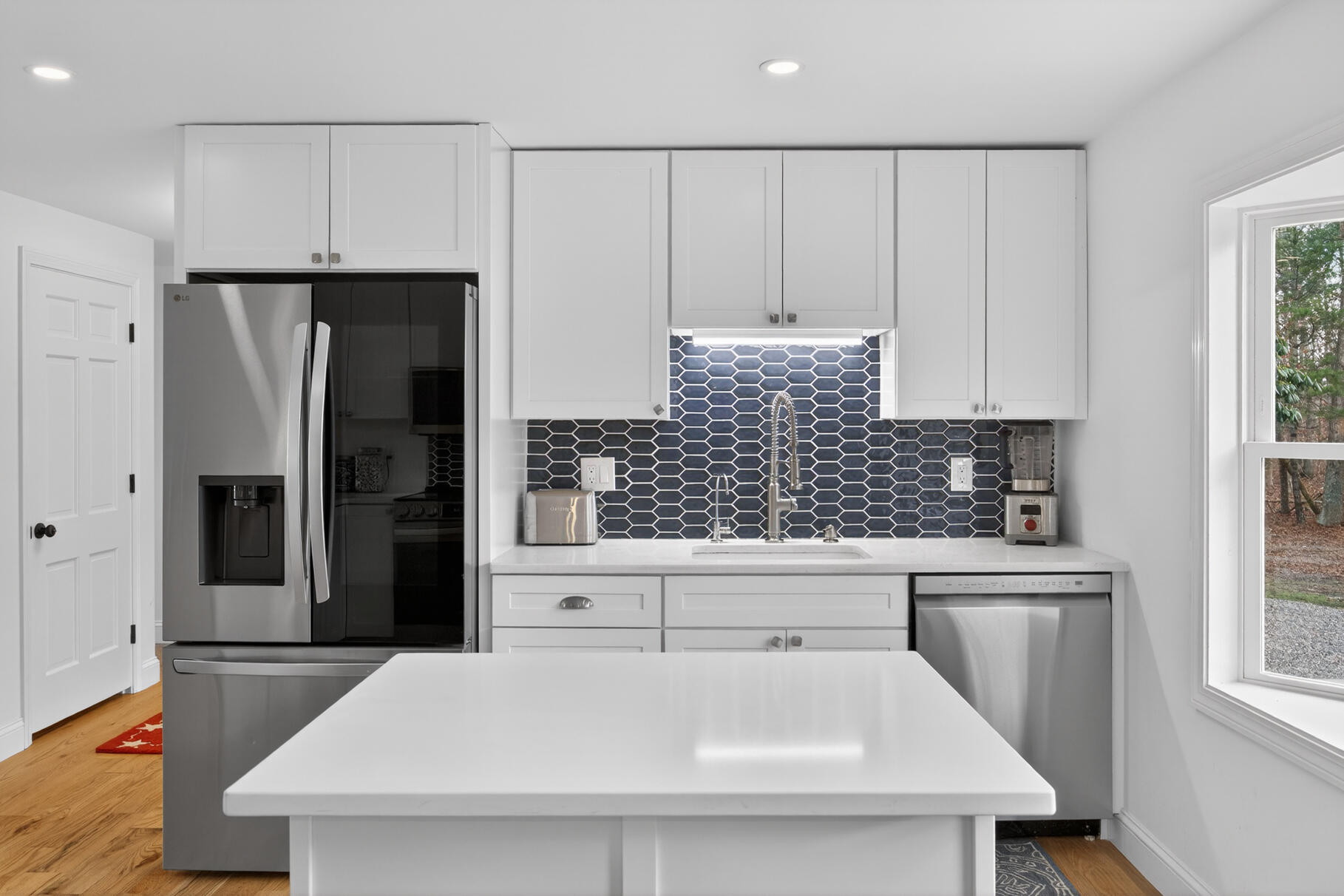 24 Surrey Lane Sandwich, MA 02563 - Photo 9 of 61 a kitchen with stainless steel appliances a refrigerator a sink and white cabinets