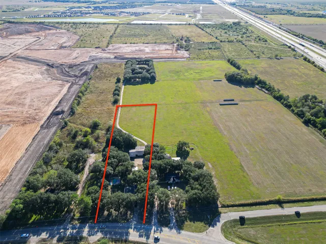 a view of a swimming pool with a yard and seating area