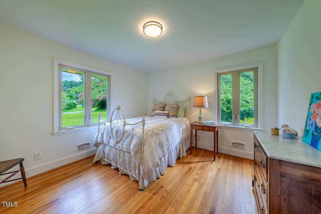 4621 Erwin Road Durham, NC 27705 - Photo 17 of 40 a bed room with a bed and a window