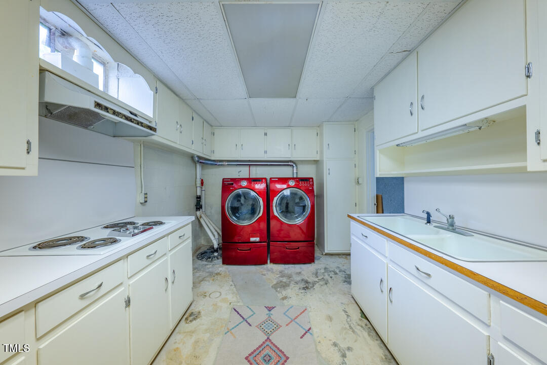 4621 Erwin Road Durham, NC 27705 - Photo 29 of 40 a utility room with stainless steel appliances granite countertop a sink a stove a refrigerator and cabinets