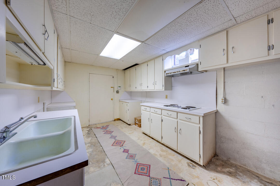 4621 Erwin Road Durham, NC 27705 - Photo 30 of 40 a kitchen with a sink stove and cabinets