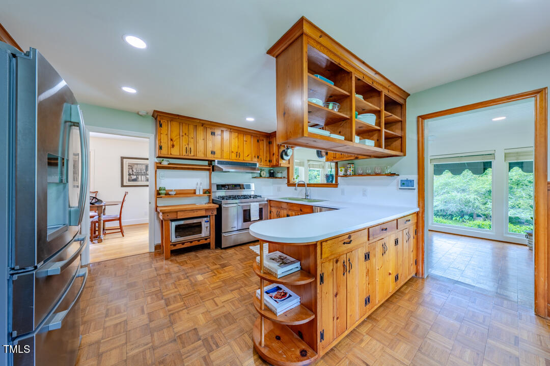 4621 Erwin Road Durham, NC 27705 - Photo 6 of 40 a view of a kitchen with stainless steel appliances granite countertop a stove and a sink