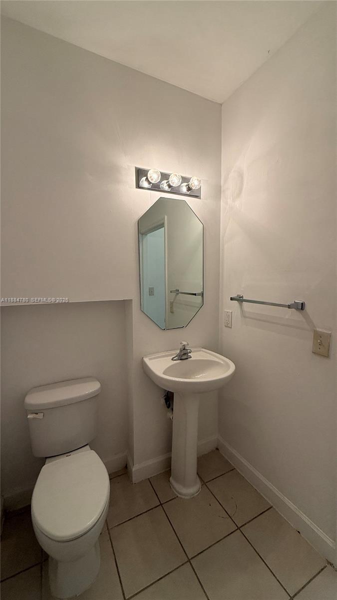 11240 Southwest 230th Terrace, Unit 11240 Miami, FL 33170 - Photo 13 of 35 a bathroom with a toilet sink and mirror