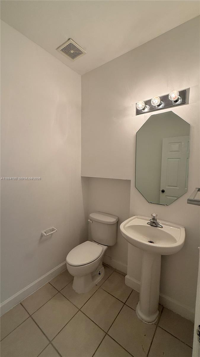 11240 Southwest 230th Terrace, Unit 11240 Miami, FL 33170 - Photo 14 of 35 a bathroom with a sink toilet and a mirror