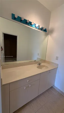 a bathroom with a sink and mirror