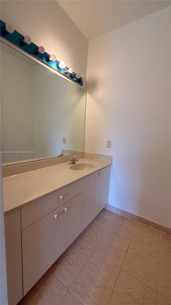 11240 Southwest 230th Terrace, Unit 11240 Miami, FL 33170 - Photo 22 of 35 a bathroom with a sink and mirror