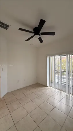 a view of an empty room and a window