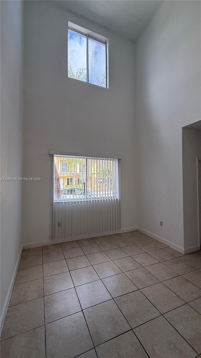 11240 Southwest 230th Terrace, Unit 11240 Miami, FL 33170 - Photo 4 of 35 a view of an empty room with a window