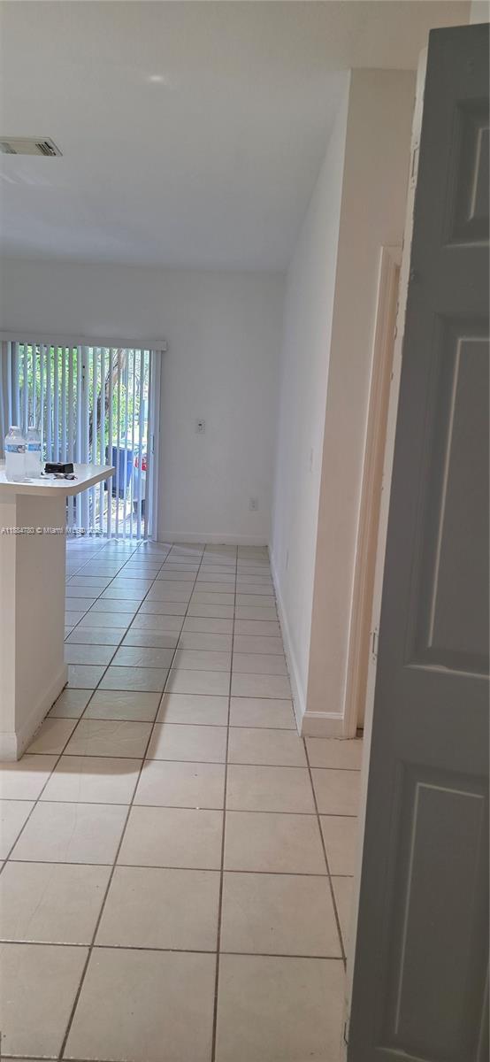 11240 Southwest 230th Terrace, Unit 11240 Miami, FL 33170 - Photo 6 of 9 a view of an empty room with a window