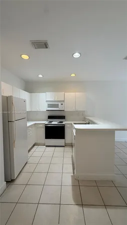 a kitchen with a cabinets and steel appliances