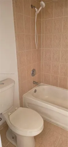 a bathroom with a toilet and a bathtub