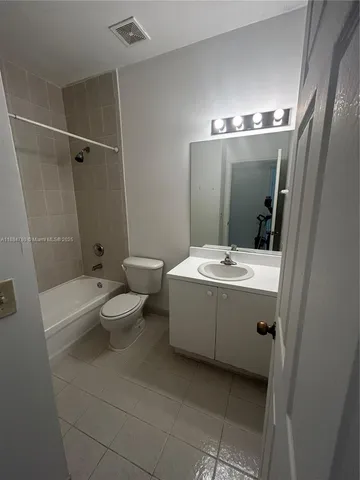a bathroom with a double vanity sink toilet and shower