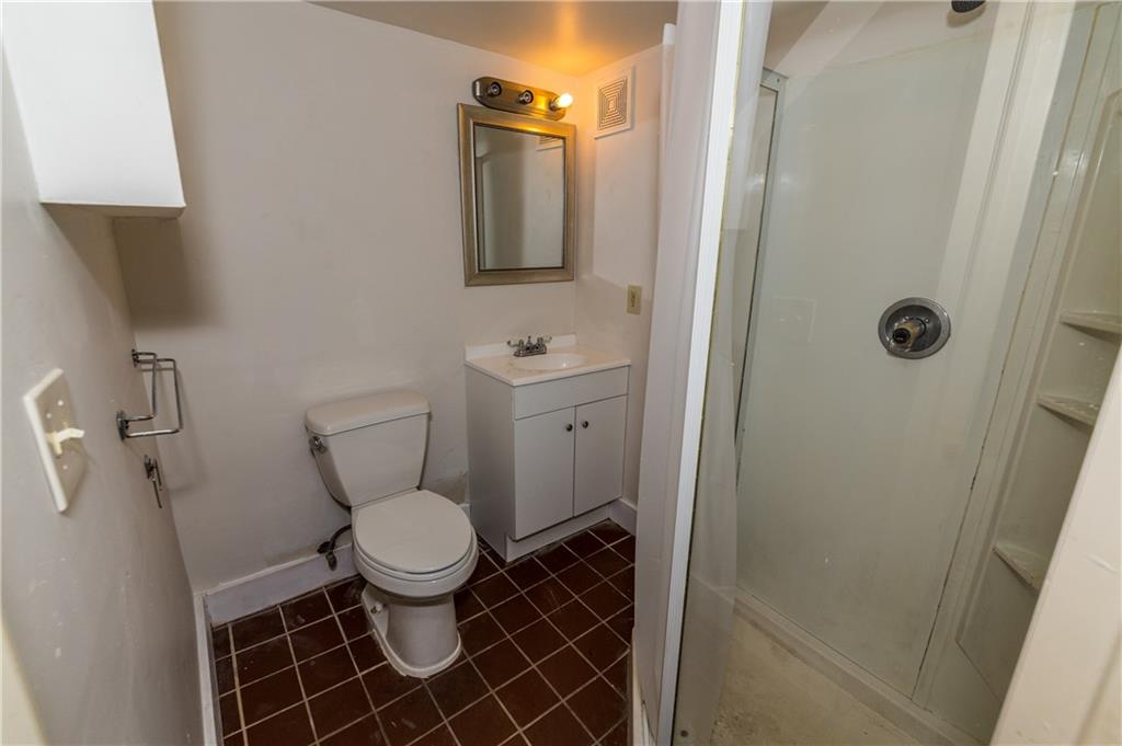 631 Beaver Road Ambridge, PA 15003 - Photo 12 of 25 Downstairs bathroom has tile floor, standing shower, new cabinetry, mirror and lighting.
