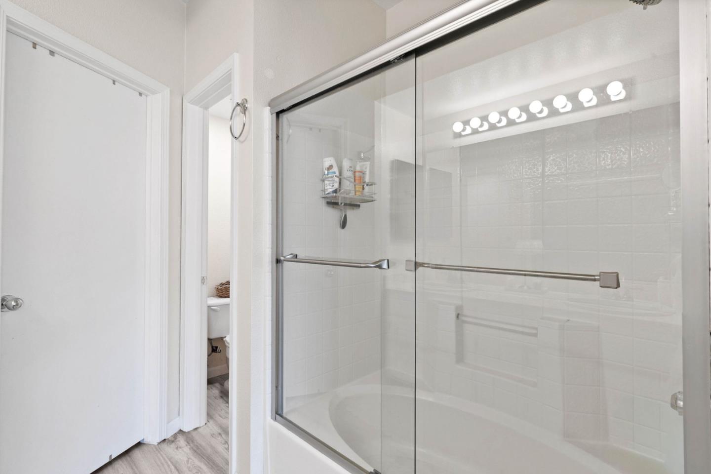 3337 Midtown Place San Jose, CA 95136 - Photo 21 of 32 a bathroom with a glass shower door and a bathtub