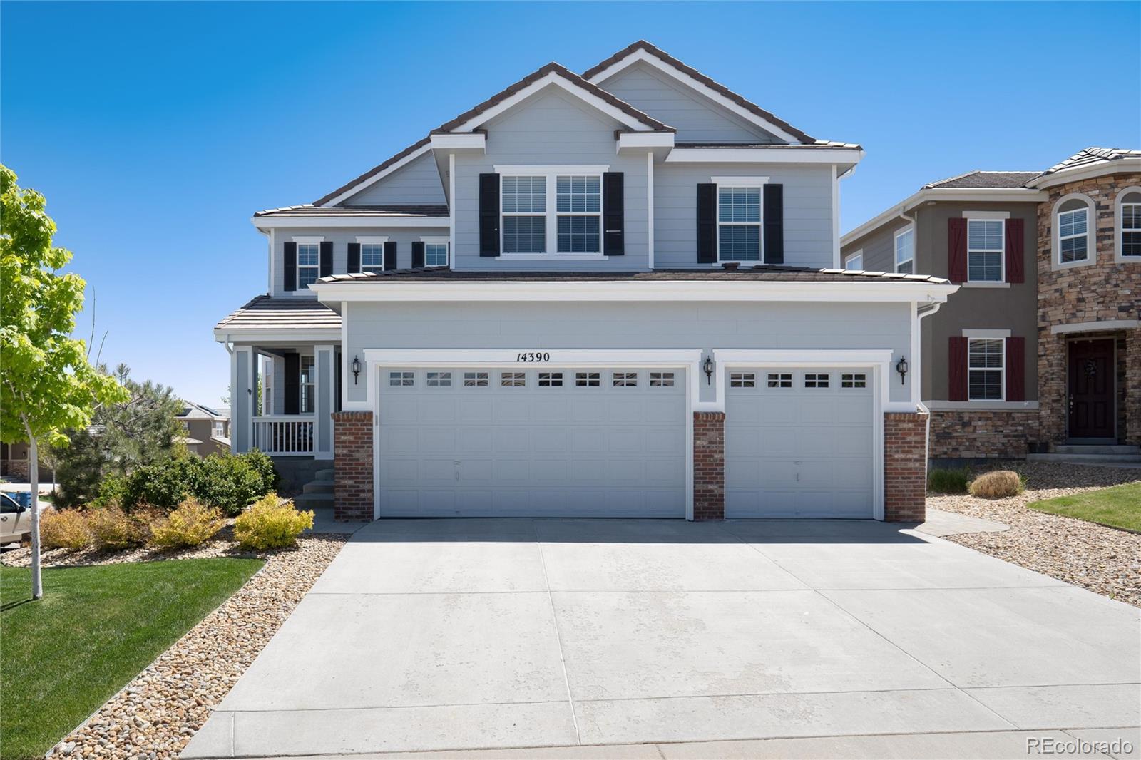14390 Double Dutch Loop Parker, CO 80134 - Photo 1 of 50 a front view of a house with a garden and plants