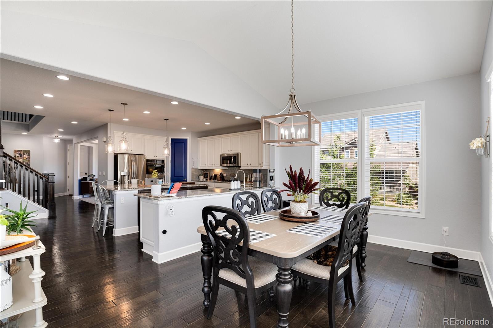 14390 Double Dutch Loop Parker, CO 80134 - Photo 16 of 50 a view of a dining room and livingroom with furniture wooden floor a chandelier