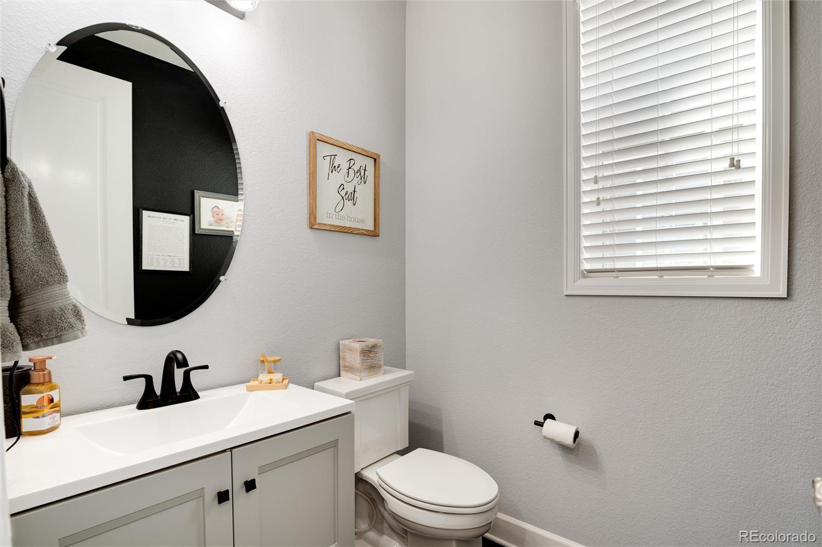 14390 Double Dutch Loop Parker, CO 80134 - Photo 21 of 50 a bathroom with a toilet sink and mirror
