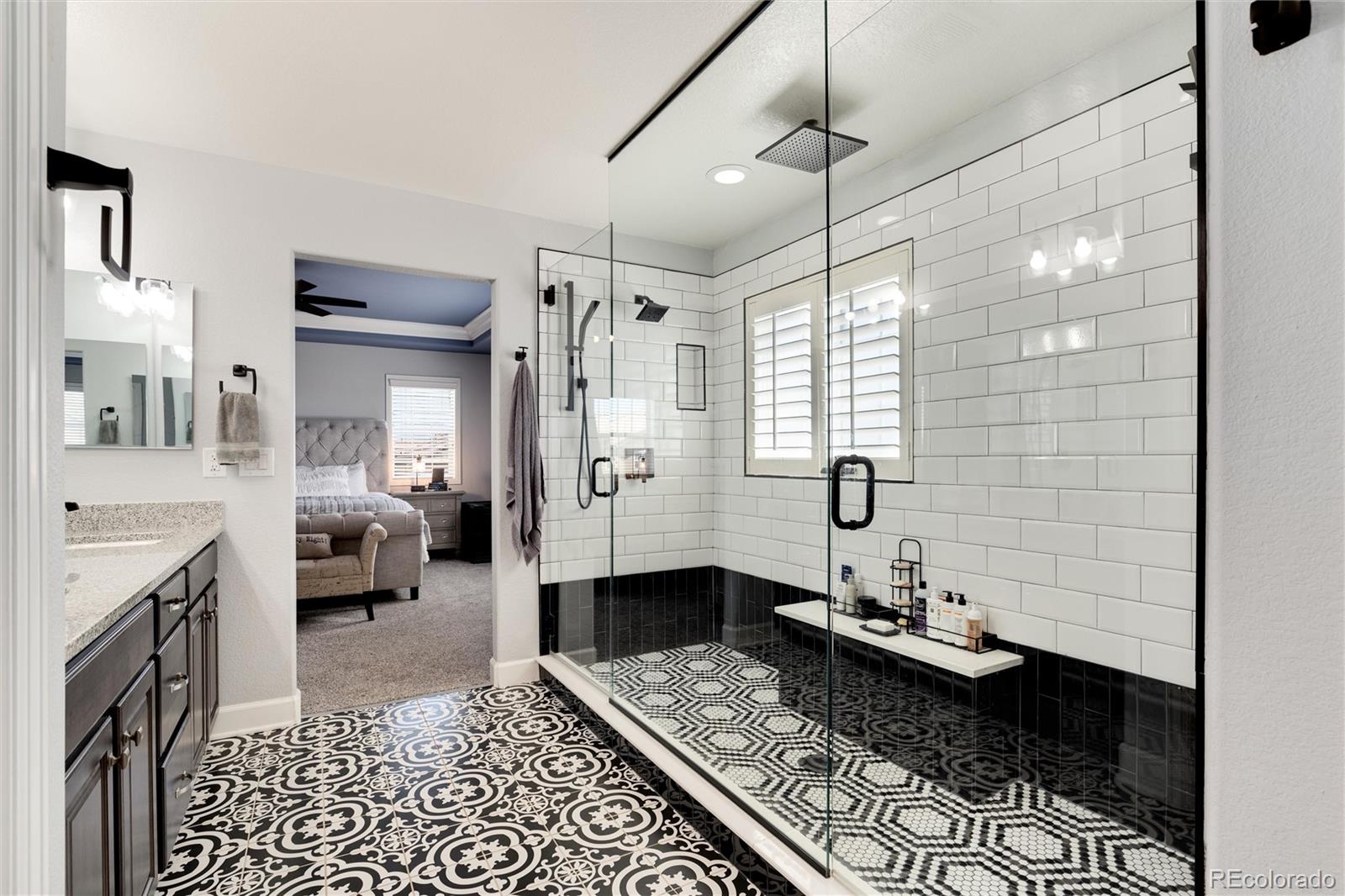 14390 Double Dutch Loop Parker, CO 80134 - Photo 29 of 50 a bathroom with a granite countertop sink a mirror and shower