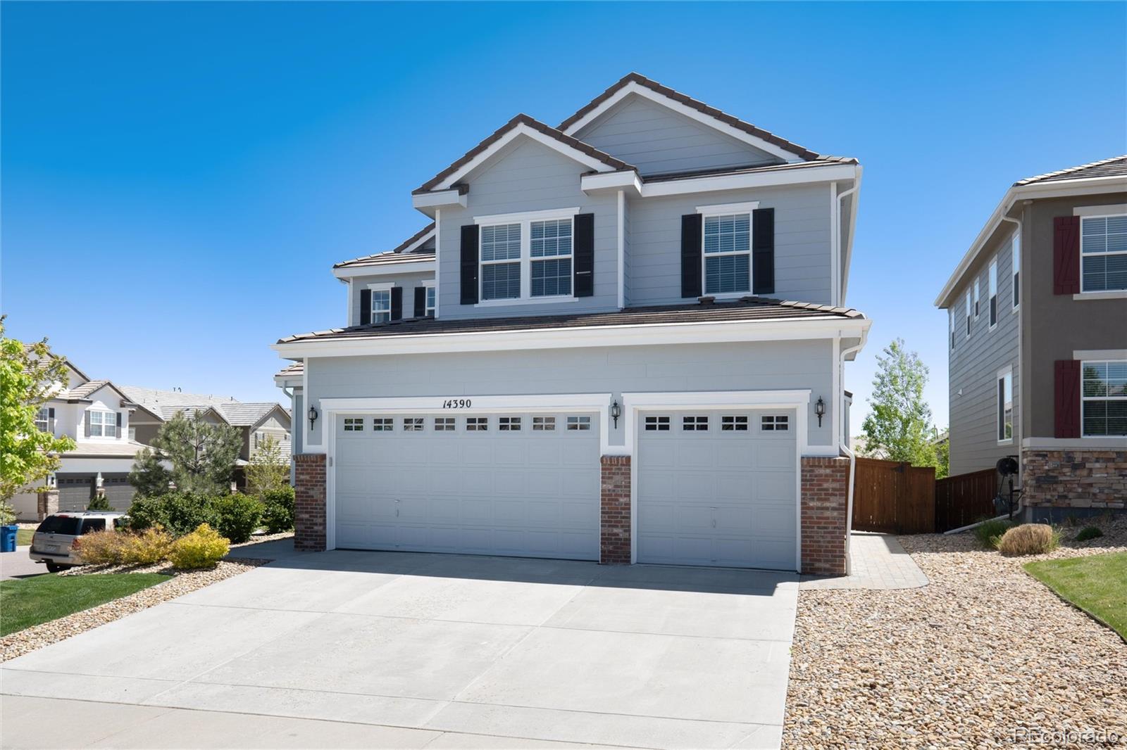 14390 Double Dutch Loop Parker, CO 80134 - Photo 3 of 50 a front view of a house with a yard and garage
