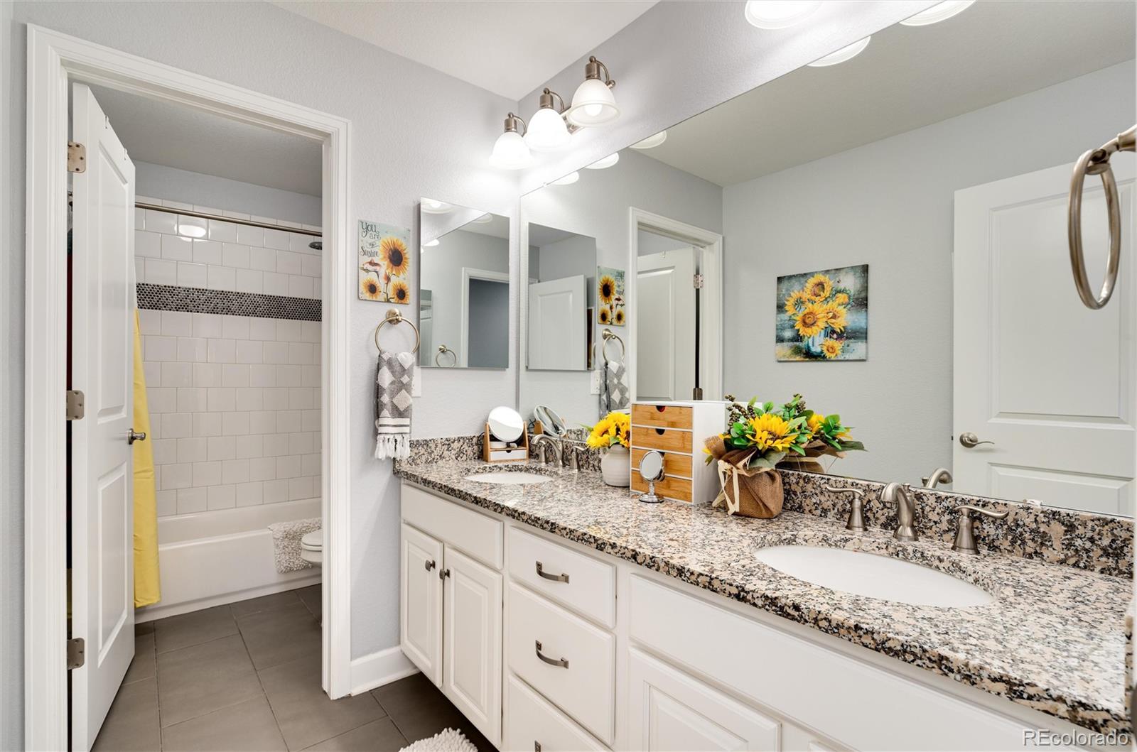 14390 Double Dutch Loop Parker, CO 80134 - Photo 32 of 50 a bathroom with a granite countertop sink mirror and a