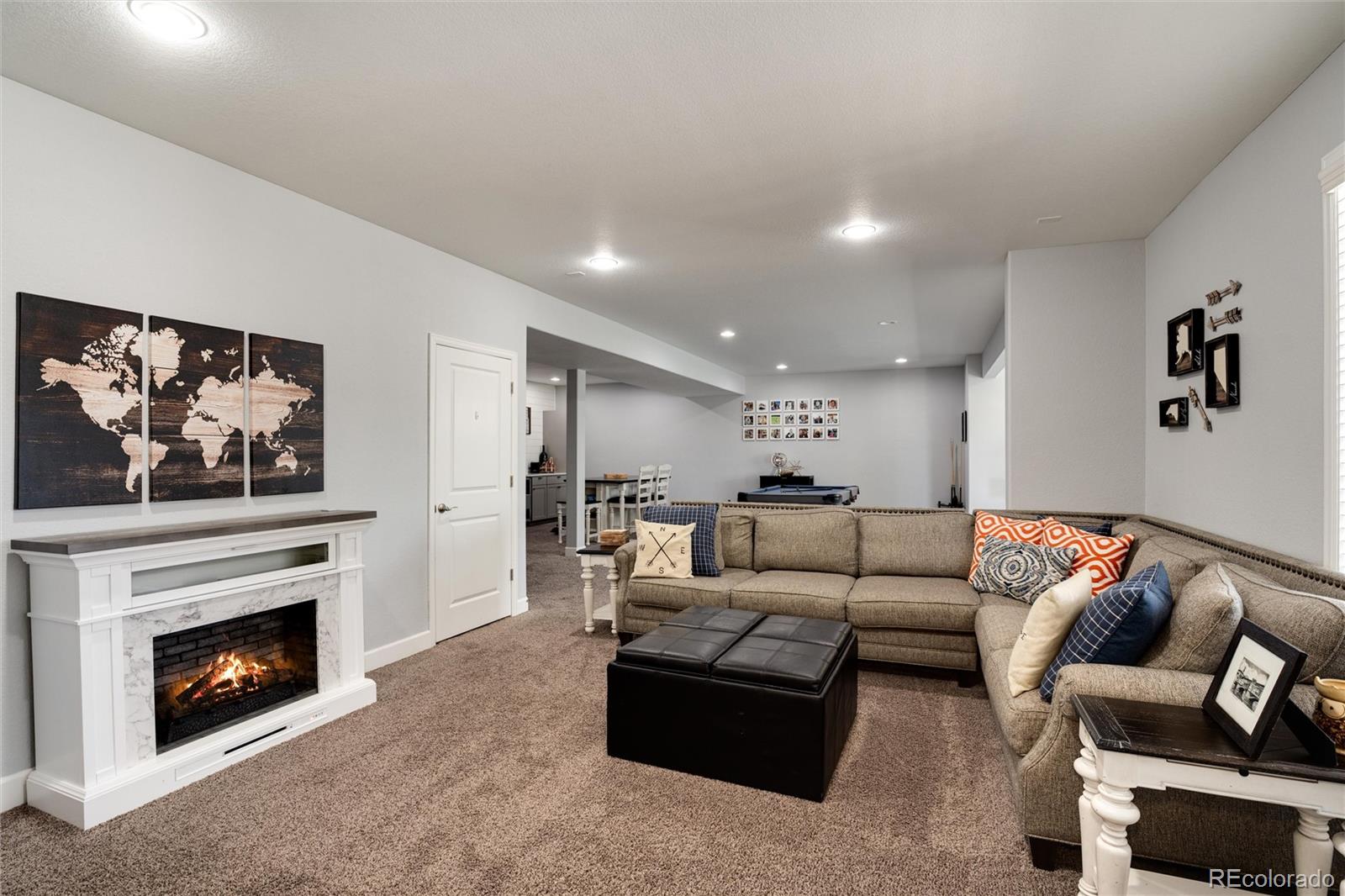 14390 Double Dutch Loop Parker, CO 80134 - Photo 39 of 50 a living room with furniture a flat screen tv and a fireplace