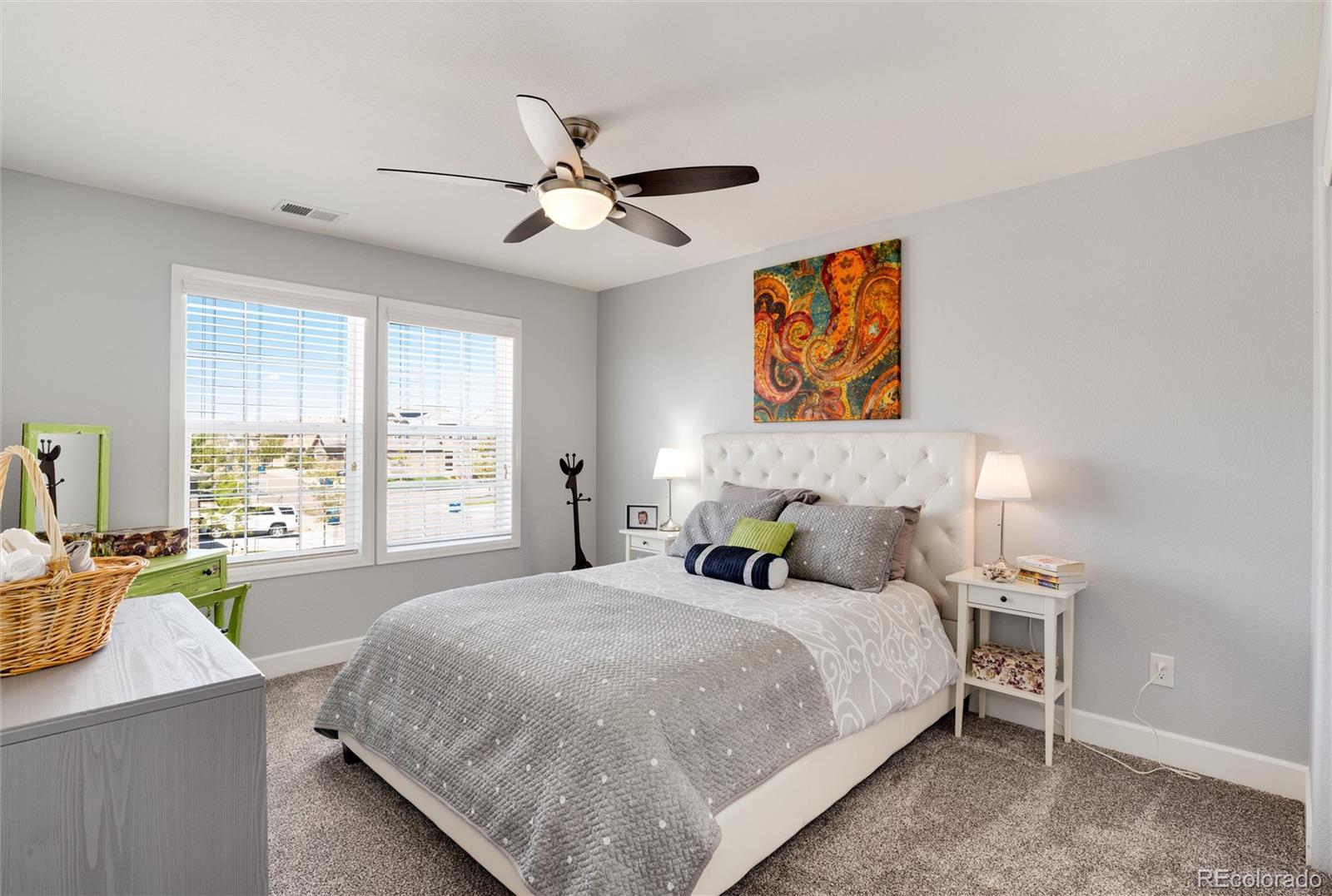 14390 Double Dutch Loop Parker, CO 80134 - Photo 41 of 50 a bedroom with a bed and wooden floor