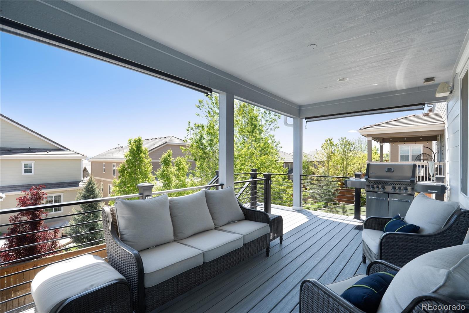 14390 Double Dutch Loop Parker, CO 80134 - Photo 43 of 50 a living room with furniture and a floor to ceiling window