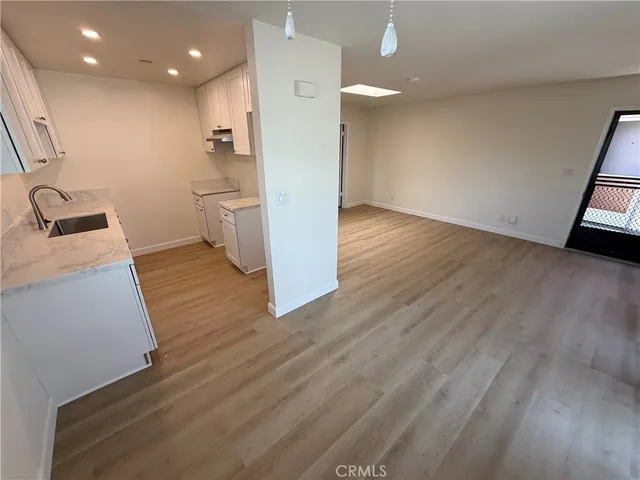 a view of a kitchen with a sink and a stove top oven