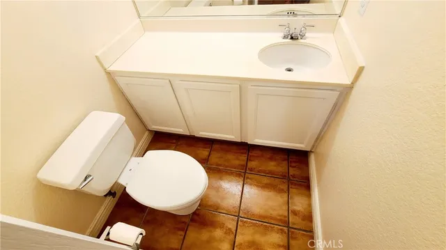 a bathroom with a sink mirror and vanity