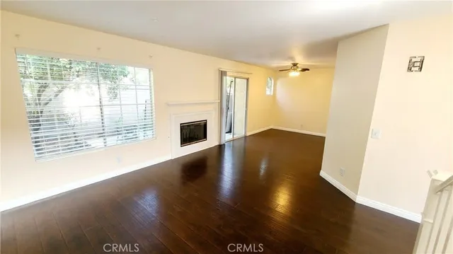 a living room with a fireplace and wooden floor