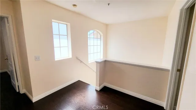 a view of a room with wooden floor