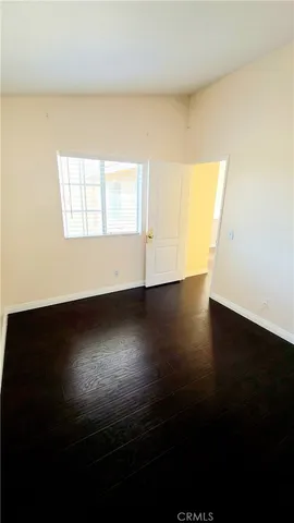 a white bath tub sitting in a backyard with potted plants