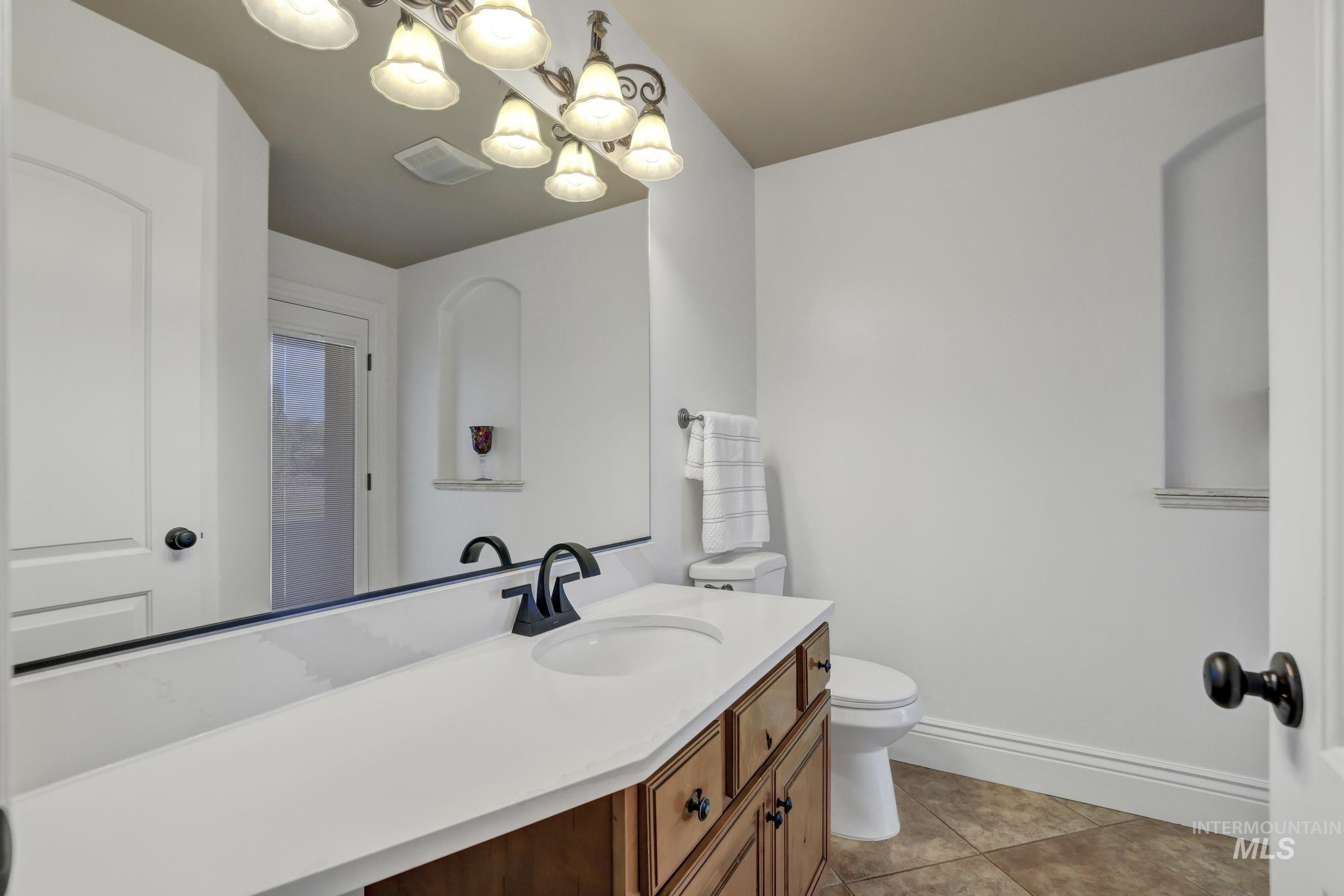 1301 Kanaka Rapids Road Buhl, ID 83316 - Photo 36 of 50 Bathroom featuring a wood-finish vanity with a white countertop, an integrated sink, and dark bronze fixtures