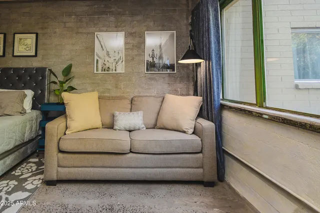 a living room with furniture and a mirror
