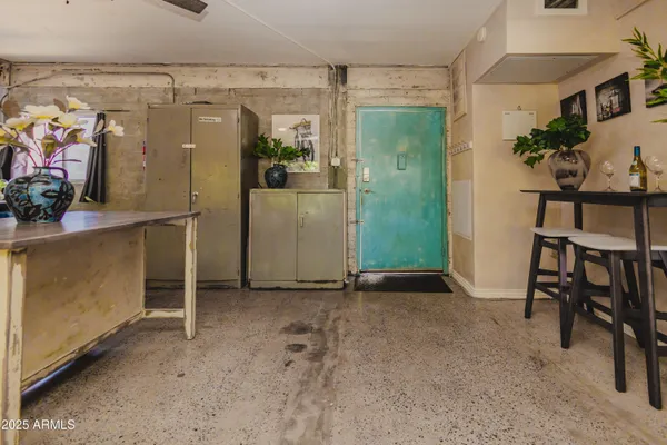 an empty room with shelves and entryway