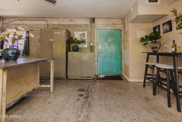 an empty room with shelves and entryway