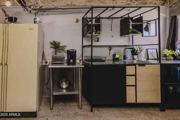 a kitchen with a refrigerator and a sink