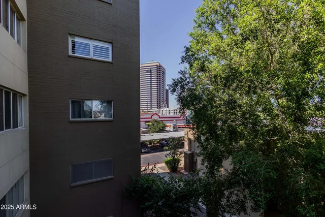 a front view of a building with trees