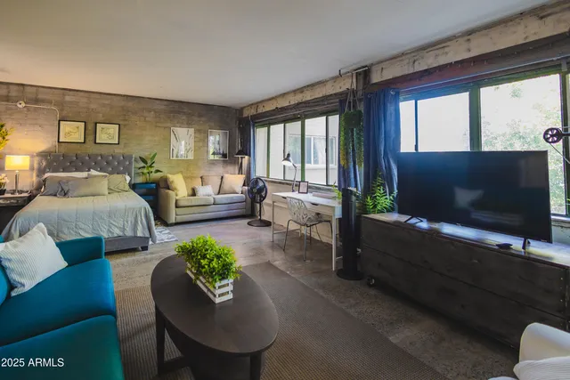 a living room with furniture and a flat screen tv