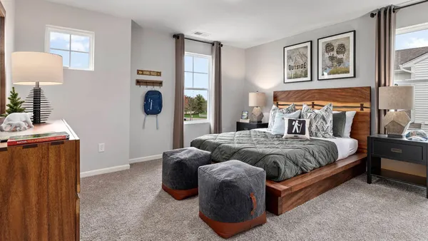 a bedroom with a bed and lamp