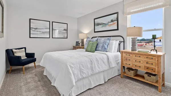 a bedroom with a bed and a chair