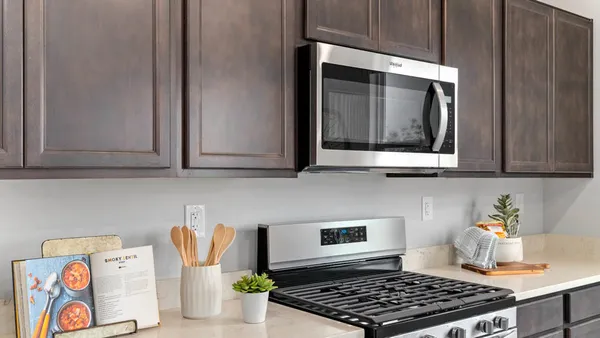 a kitchen with wooden cabinets and a stove top oven