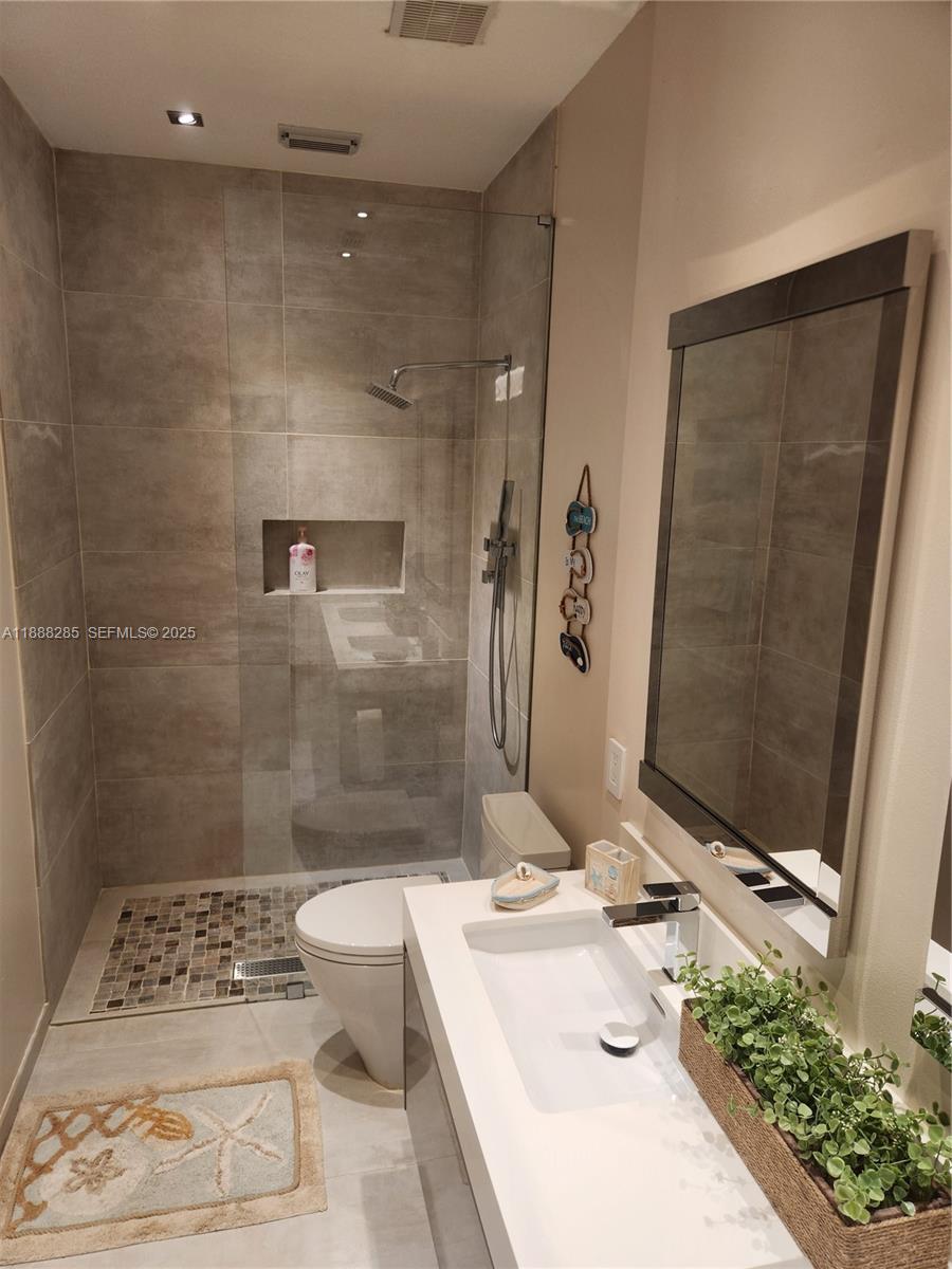 16411 Southwest 60th Terrace Miami, FL 33193 - Photo 11 of 37 a bathroom with a sink a toilet and shower