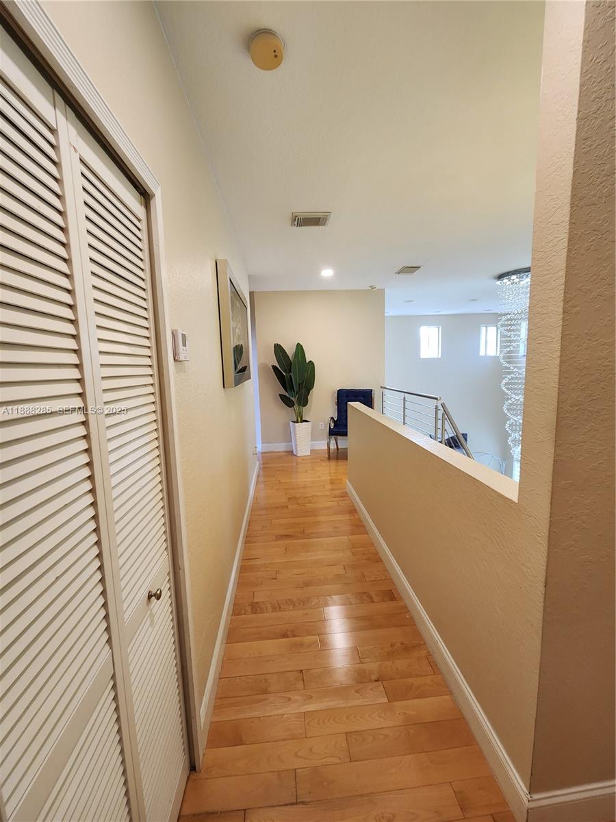 16411 Southwest 60th Terrace Miami, FL 33193 - Photo 12 of 37 a view of a hallway with wooden floor and staircase