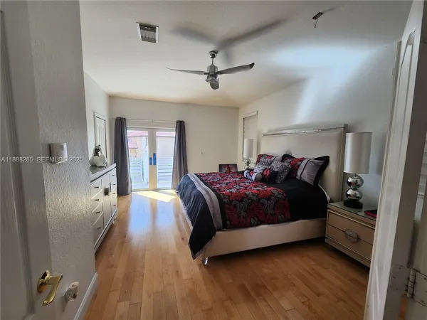 a spacious bedroom with a bed and large windows