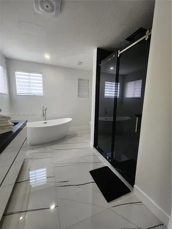 a spacious bathroom with a bathtub and a shower